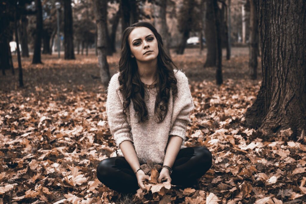 PTSD symptoms can appear at any time, as they do in this woman in the woods.